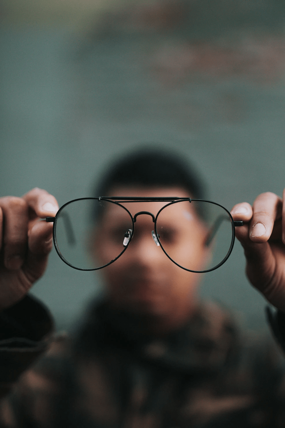 *The image is of a person holding up a pair of glasses away from their face. Photographer - Nathan Dumlao via UnSplash